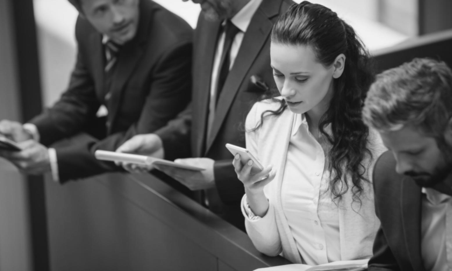 Professional testing coordination meeting with team members reviewing software implementation results